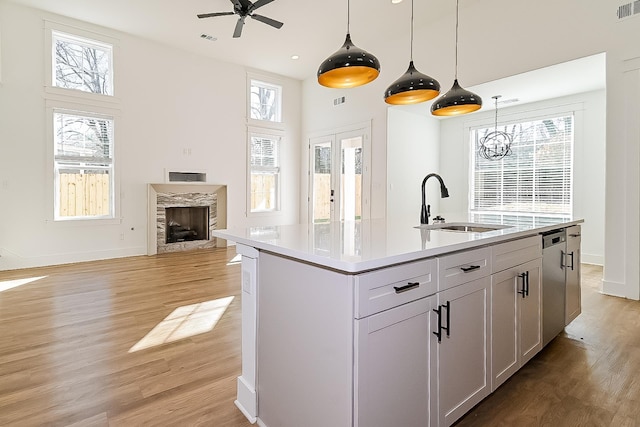 3615 Kearney Ave, Memphis, TN 38111 - kitchen featuring a ceiling fan, light wood-style floors, a fireplace, plenty of natural light, and a towering ceiling