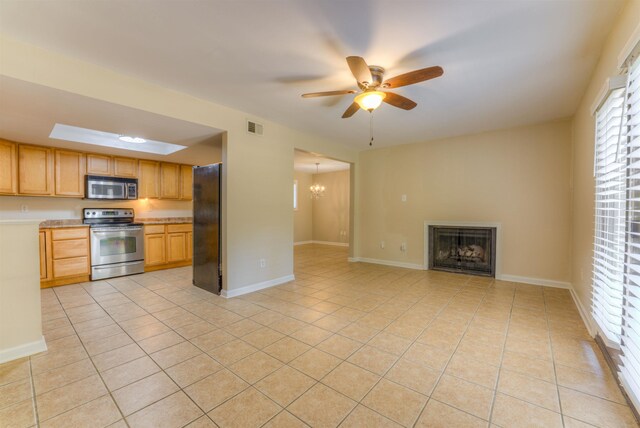 1841 Fernspring Cv Unit 26, Germantown, TN 38138 - kitchen featuring appliances with stainless steel finishes, light tile patterned floors, ceiling fan, light countertops, and a fireplace