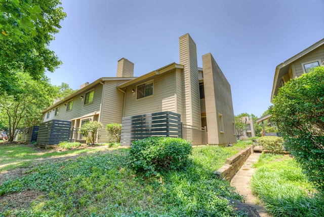 1841 Fernspring Cv Unit 26, Germantown, TN 38138 - rear view of property with a chimney