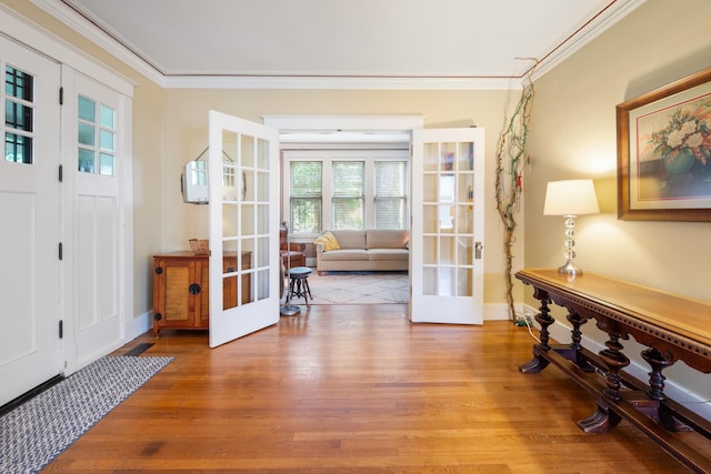 1668 Forest Ave, Memphis, TN 38112 - foyer entrance with french doors, light wood-style flooring, and ornamental molding