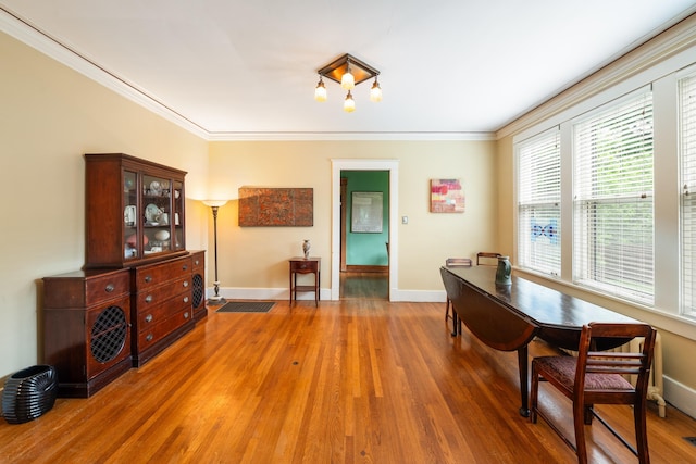 1668 Forest Ave, Memphis, TN 38112 - dining area with wood finished floors and ornamental molding