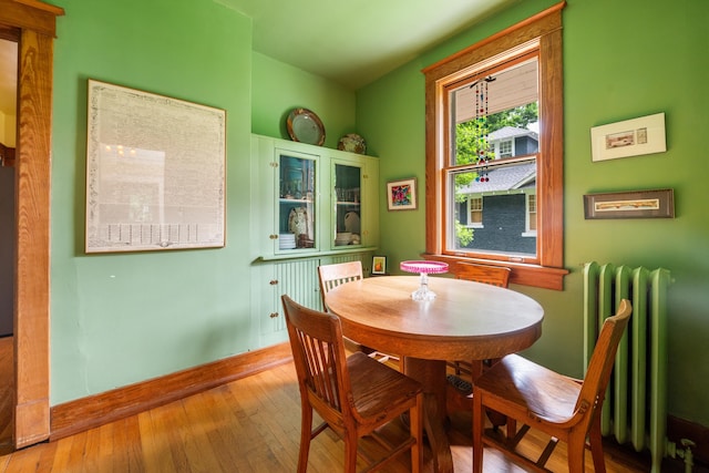 1668 Forest Ave, Memphis, TN 38112 - dining area with radiator and hardwood / wood-style floors