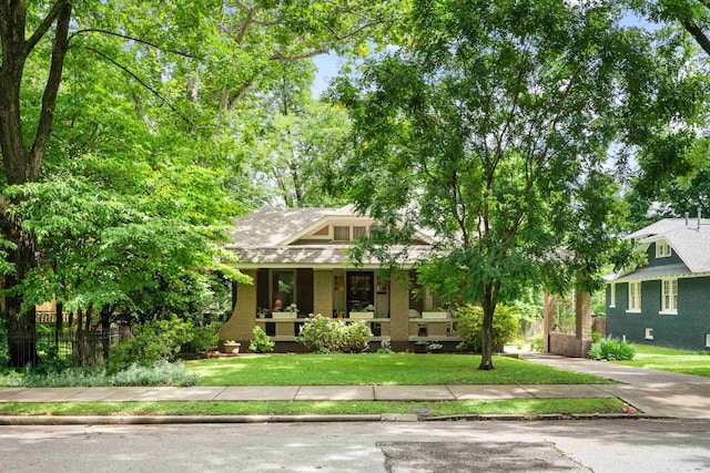 1668 Forest Ave, Memphis, TN 38112 - view of front of house with brick siding and covered porch