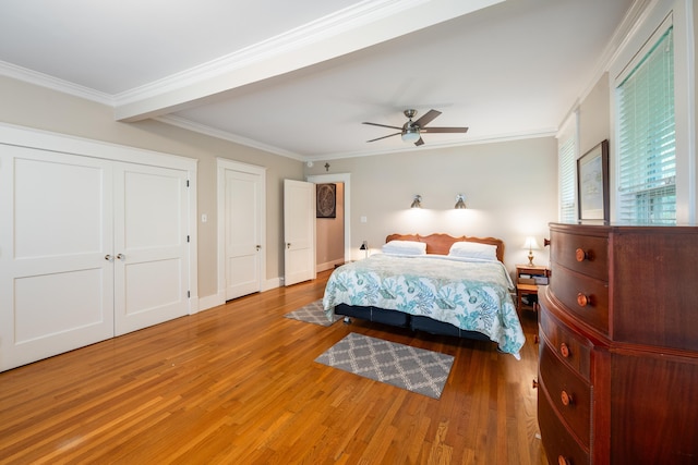 1668 Forest Ave, Memphis, TN 38112 - bedroom with wood finished floors, crown molding, ceiling fan, and two closets