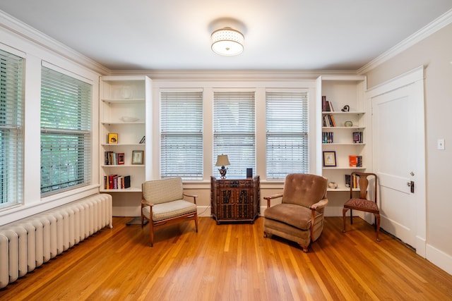 1668 Forest Ave, Memphis, TN 38112 - sitting room with radiator, light wood-style flooring, crown molding, and built in features