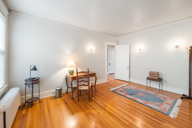 1668 Forest Ave, Memphis, TN 38112 - living area with radiator, light wood-style floors, and crown molding