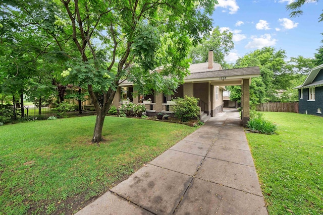 1668 Forest Ave, Memphis, TN 38112 - view of front of home featuring driveway, a chimney, brick siding, and a shingled roof