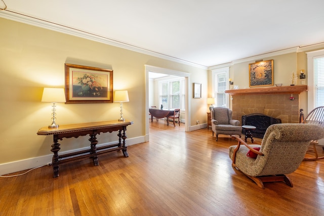 1668 Forest Ave, Memphis, TN 38112 - sitting room with crown molding, wood finished floors, and a brick fireplace