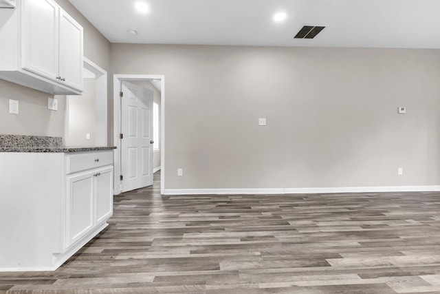 764 Garland St, Memphis, TN 38107 - kitchen featuring light wood finished floors, white cabinets, recessed lighting, and dark stone countertops