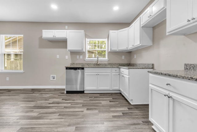 764 Garland St, Memphis, TN 38107 - kitchen with dishwasher, recessed lighting, light wood-style flooring, light stone counters, and white cabinets