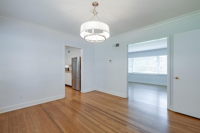 5208 Gwynne Rd, Memphis, TN 38117 - spare room with crown molding, a chandelier, and wood finished floors