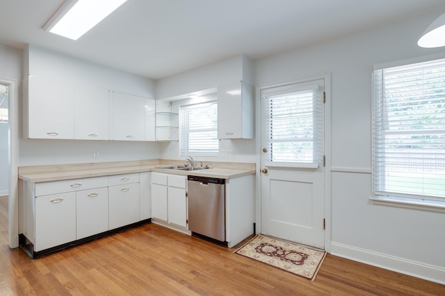 5208 Gwynne Rd, Memphis, TN 38117 - kitchen with dishwasher, light wood-type flooring, white cabinetry, and light countertops
