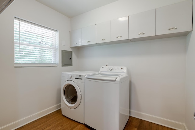 5208 Gwynne Rd, Memphis, TN 38117 - washroom featuring electric panel, cabinet space, washing machine and clothes dryer, and wood finished floors
