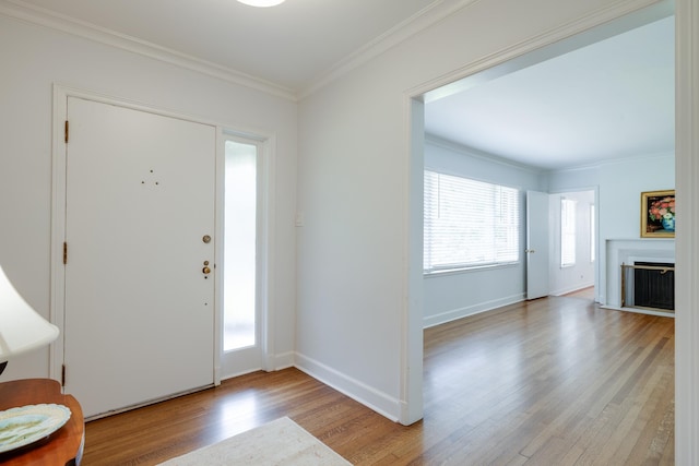 5208 Gwynne Rd, Memphis, TN 38117 - entrance foyer with light wood-type flooring, ornamental molding, and a fireplace