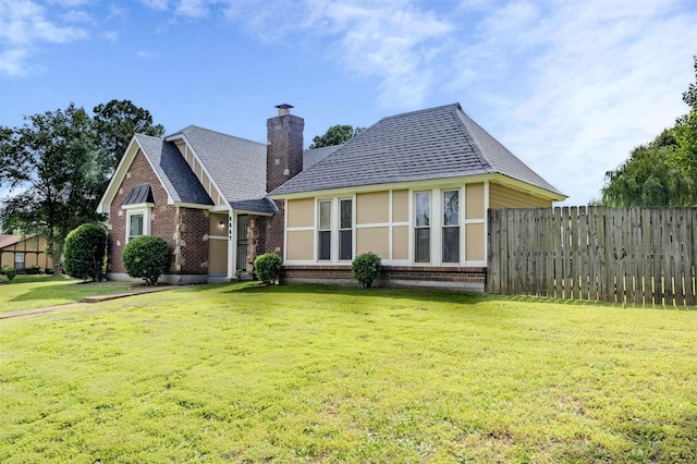 4447 Ross Rd, Memphis, TN 38141 - back of house featuring brick siding, roof with shingles, and a chimney