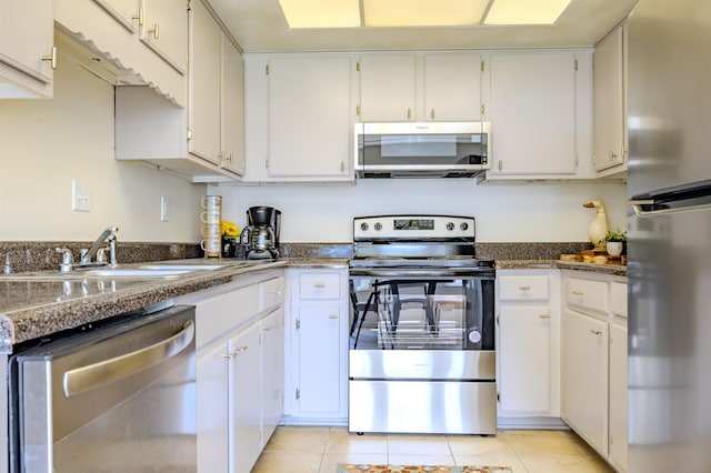 4447 Ross Rd, Memphis, TN 38141 - kitchen with appliances with stainless steel finishes, light tile patterned flooring, and white cabinets