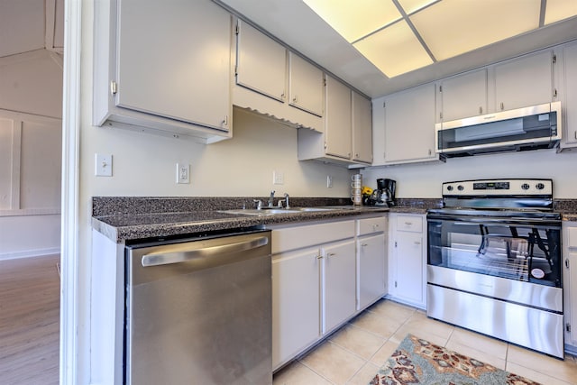 4447 Ross Rd, Memphis, TN 38141 - kitchen featuring appliances with stainless steel finishes, dark countertops, and light tile patterned floors