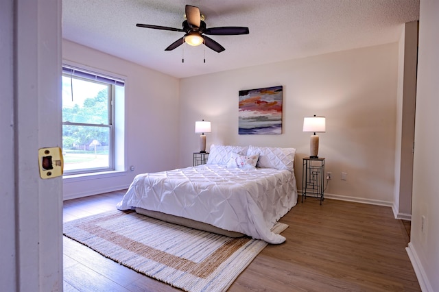 4447 Ross Rd, Memphis, TN 38141 - bedroom featuring wood finished floors, a ceiling fan, and a textured ceiling