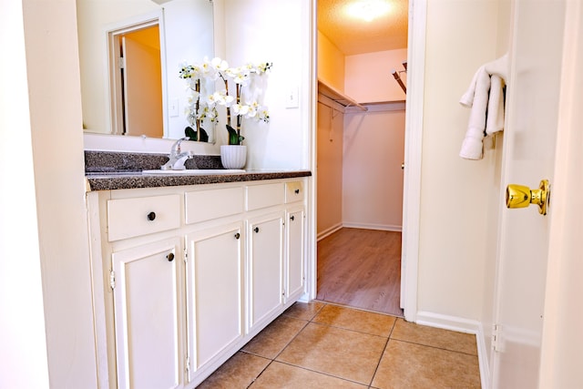 4447 Ross Rd, Memphis, TN 38141 - bathroom with vanity, tile patterned floors, and a walk in closet