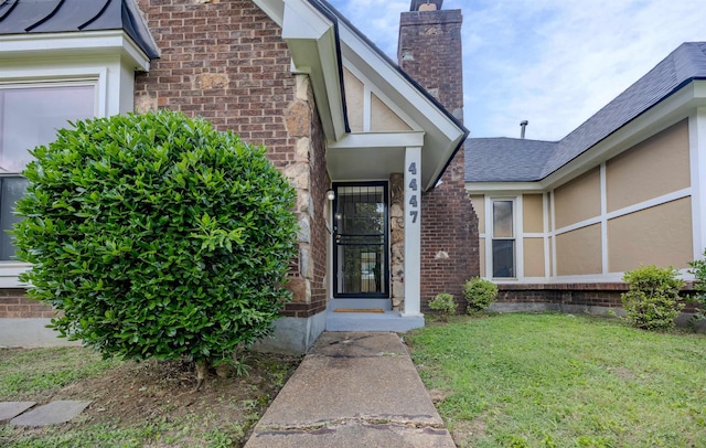 4447 Ross Rd, Memphis, TN 38141 - property entrance featuring a lawn, brick siding, and a chimney