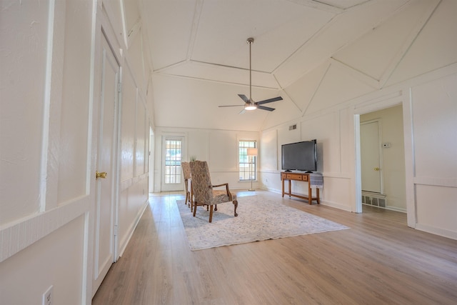 4447 Ross Rd, Memphis, TN 38141 - living area with light wood-type flooring, ceiling fan, a decorative wall, and high vaulted ceiling