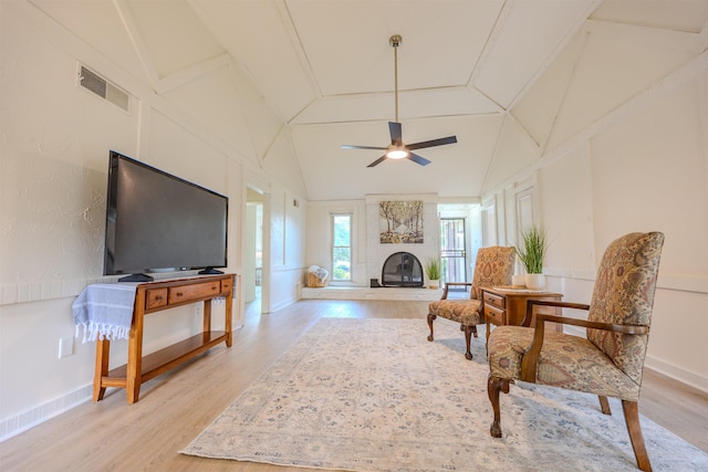 4447 Ross Rd, Memphis, TN 38141 - living area with light wood-type flooring, a ceiling fan, a fireplace, and lofted ceiling