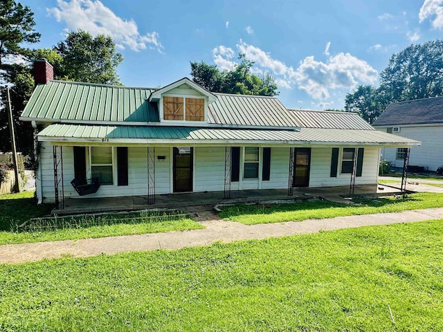 312 Pharr Ave, Selmer, TN 38375 - view of front of property with a porch, a front lawn, a metal roof, and a chimney