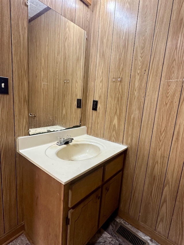 312 Pharr Ave, Selmer, TN 38375 - bathroom featuring vanity and wood walls
