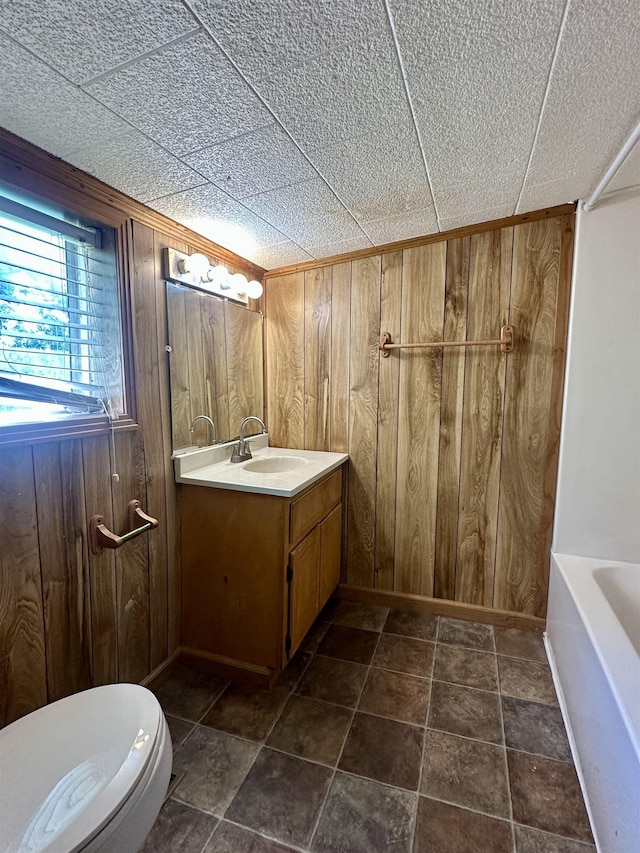 312 Pharr Ave, Selmer, TN 38375 - full bath with wood walls, vanity, and a tub