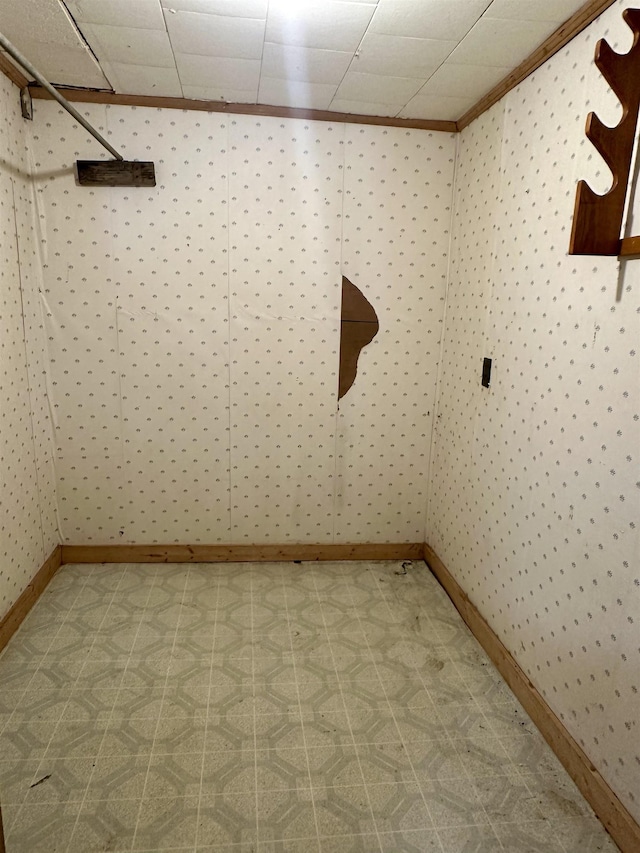 312 Pharr Ave, Selmer, TN 38375 - empty room with tile patterned floors, wallpapered walls, and ornamental molding
