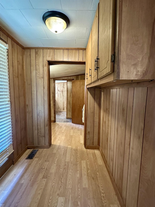 312 Pharr Ave, Selmer, TN 38375 - corridor with light wood-type flooring and wooden walls