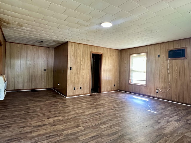 312 Pharr Ave, Selmer, TN 38375 - unfurnished room featuring dark wood-style flooring, wood walls, and a wall mounted air conditioner