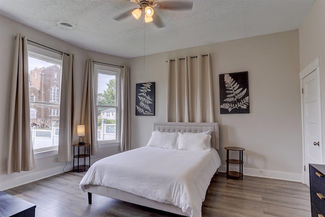 1680 Euclid Ave, Memphis, TN 38114 - bedroom featuring wood finished floors, a textured ceiling, and ceiling fan