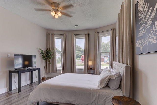 1680 Euclid Ave, Memphis, TN 38114 - bedroom with a textured ceiling, wood finished floors, and ceiling fan