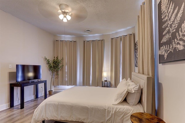 1680 Euclid Ave, Memphis, TN 38114 - bedroom with a textured ceiling, wood finished floors, and a ceiling fan
