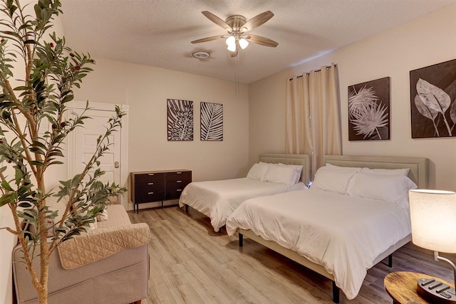 1680 Euclid Ave, Memphis, TN 38114 - bedroom featuring light wood finished floors, a textured ceiling, and ceiling fan
