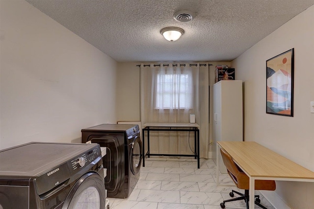 1680 Euclid Ave, Memphis, TN 38114 - laundry area featuring light marble finish flooring, washer and dryer, and a textured ceiling