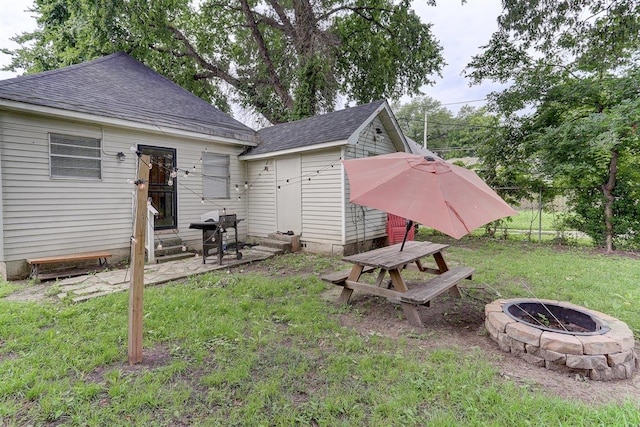 1680 Euclid Ave, Memphis, TN 38114 - rear view of property with entry steps, a fire pit, and roof with shingles