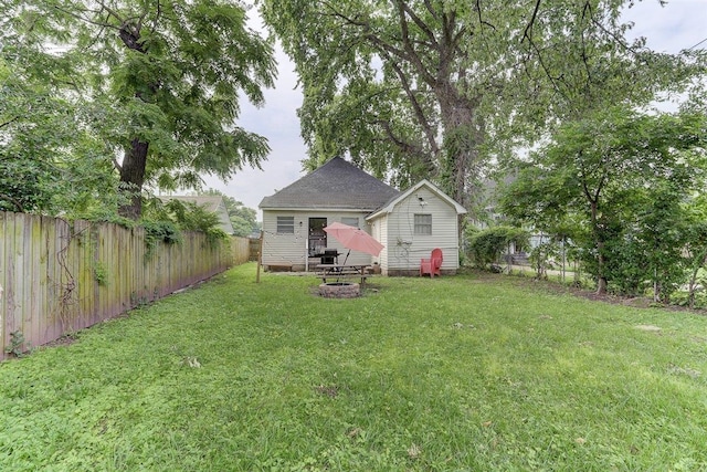 1680 Euclid Ave, Memphis, TN 38114 - back of property with a fenced backyard, a fire pit, and an outbuilding