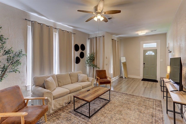 1680 Euclid Ave, Memphis, TN 38114 - living area featuring light wood finished floors, a ceiling fan, and a textured wall