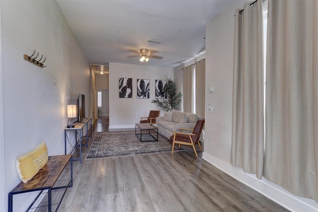 1680 Euclid Ave, Memphis, TN 38114 - living room featuring wood finished floors, ceiling fan, and healthy amount of natural light