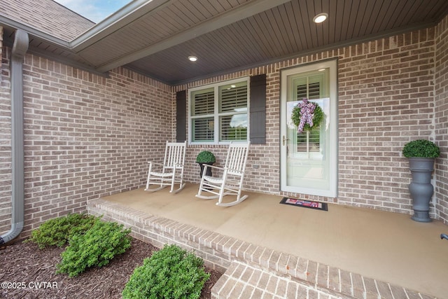571 Todd Ray Cv, Henderson, TN 38340 - property entrance with covered porch, brick siding, and roof with shingles