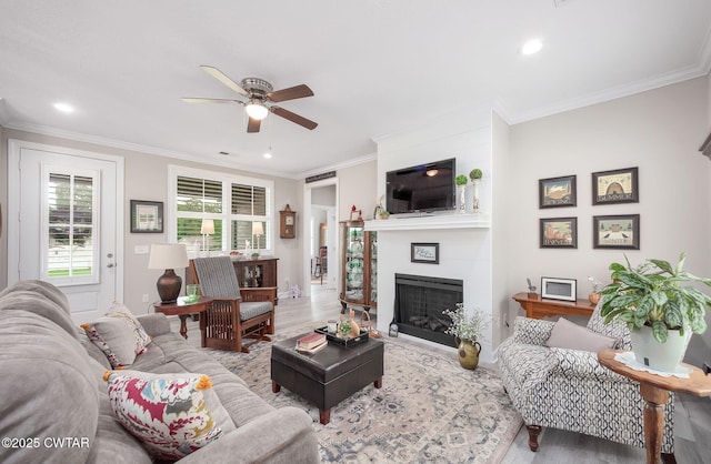 571 Todd Ray Cv, Henderson, TN 38340 - living room featuring wood finished floors, ceiling fan, a large fireplace, crown molding, and recessed lighting