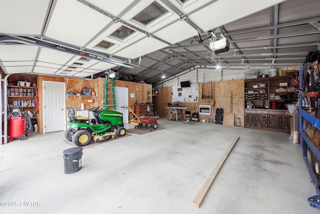 571 Todd Ray Cv, Henderson, TN 38340 - garage with a garage door opener and a workshop area