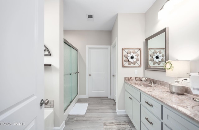 571 Todd Ray Cv, Henderson, TN 38340 - bathroom with vanity, wood finished floors, and a stall shower