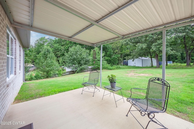 571 Todd Ray Cv, Henderson, TN 38340 - view of patio featuring view of wooded area and a storage unit