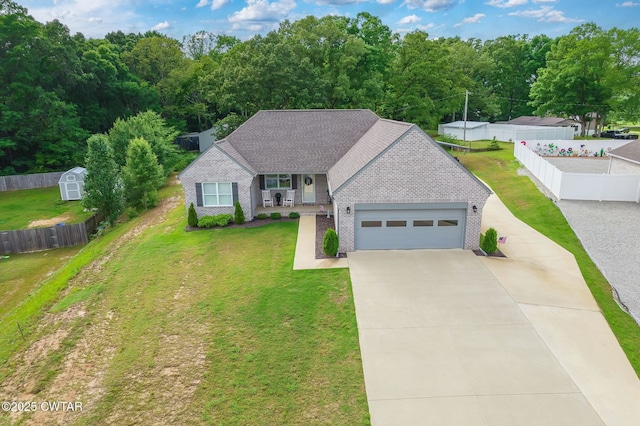 571 Todd Ray Cv, Henderson, TN 38340 - traditional home with brick siding, a garage, driveway, a porch, and a storage unit