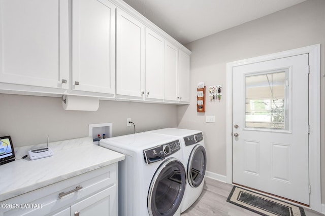 571 Todd Ray Cv, Henderson, TN 38340 - laundry area with cabinet space, light wood-style floors, and washer and dryer