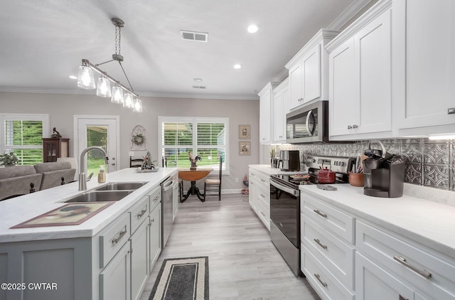 571 Todd Ray Cv, Henderson, TN 38340 - kitchen with appliances with stainless steel finishes, plenty of natural light, light countertops, recessed lighting, and white cabinets