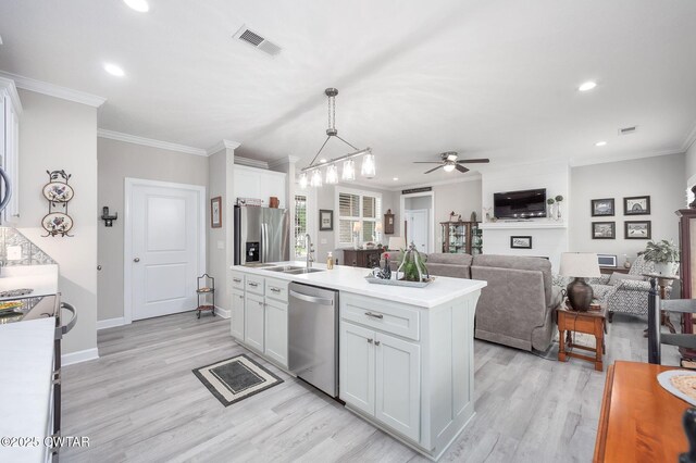 571 Todd Ray Cv, Henderson, TN 38340 - kitchen with appliances with stainless steel finishes, a ceiling fan, recessed lighting, light countertops, and light wood-style floors